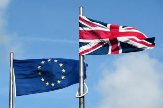 A file picture take on September 24, 2015 shows the European union and Union flag flying outside the national assembly building in Cardiff. A cross-party campaign to take Britain out of the European Union launched on October 8, 2015, backed by three major political donors ahead of a referendum expected by 2017. AFP PHOTO / DAMIEN MEYER