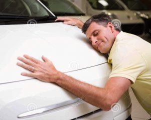 http://www.dreamstime.com/royalty-free-stock-images-smiling-man-hugging-white-car-new-showroom-image49230209